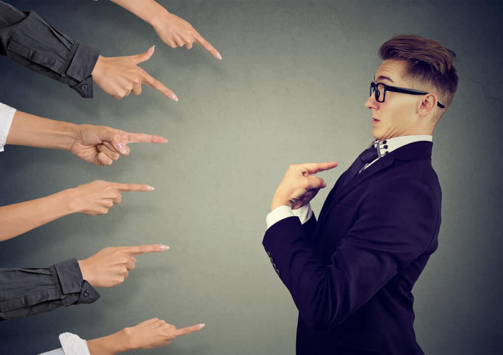 blaming you. anxious man judged by different people pointing fingers at him. negative human emotions feeling