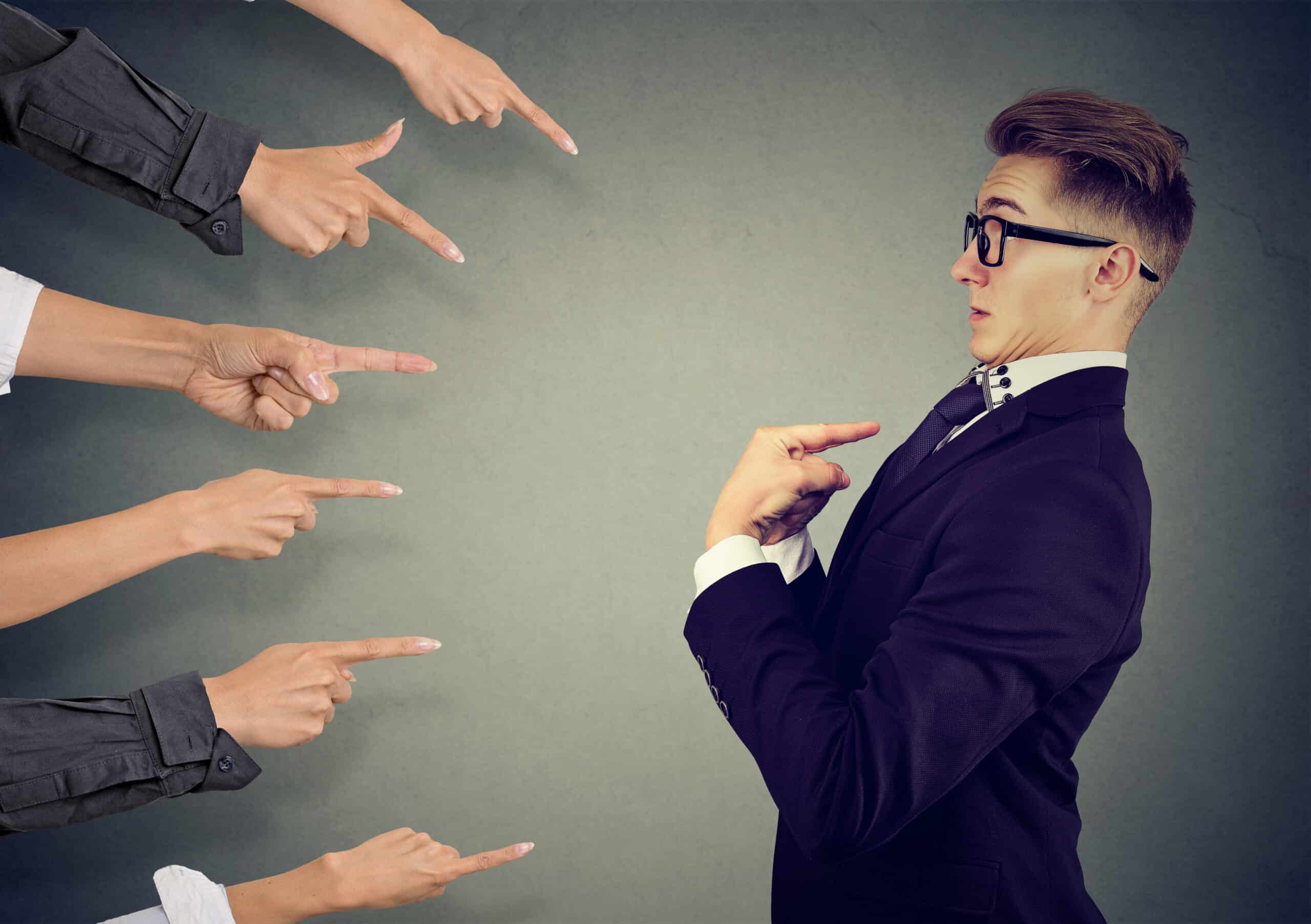 blaming you. anxious man judged by different people pointing fingers at him. negative human emotions feeling