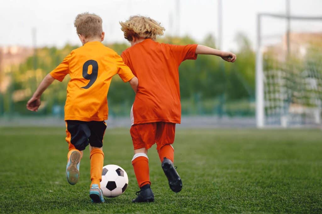 two kids playing football